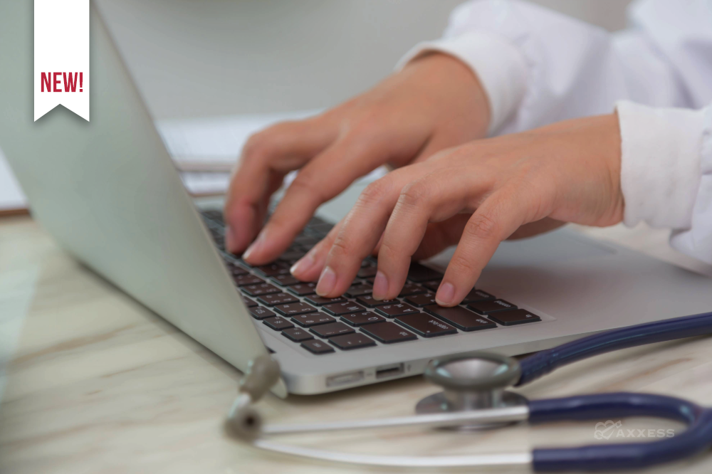 A nurse is typing on a laptop with a stethoscope laying on the desk.