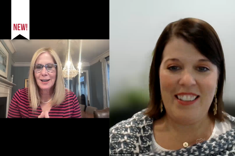 A split screen displays two women engaged in a video call. On the left, a blonde woman with glasses, dressed in a red and black striped shirt, is actively speaking. On the right, a brunette woman, adorned with a gray knitted scarf and gold earrings, is also contributing to the conversation.